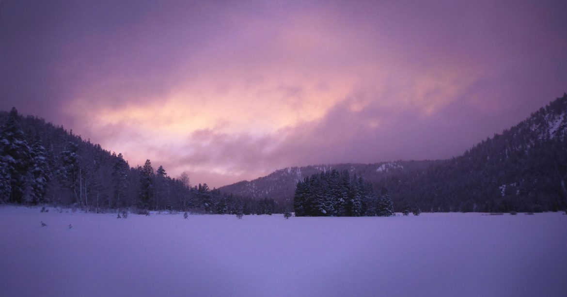 Purple sunset over snowy mountains